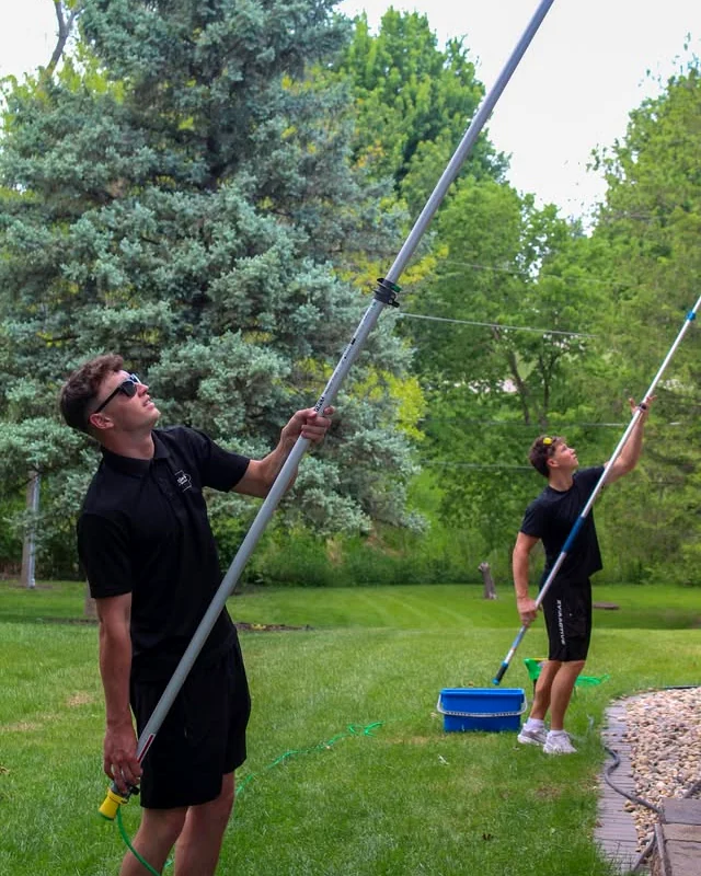 NextGen Home Services crew cleaning second-story windows with water-fed poles